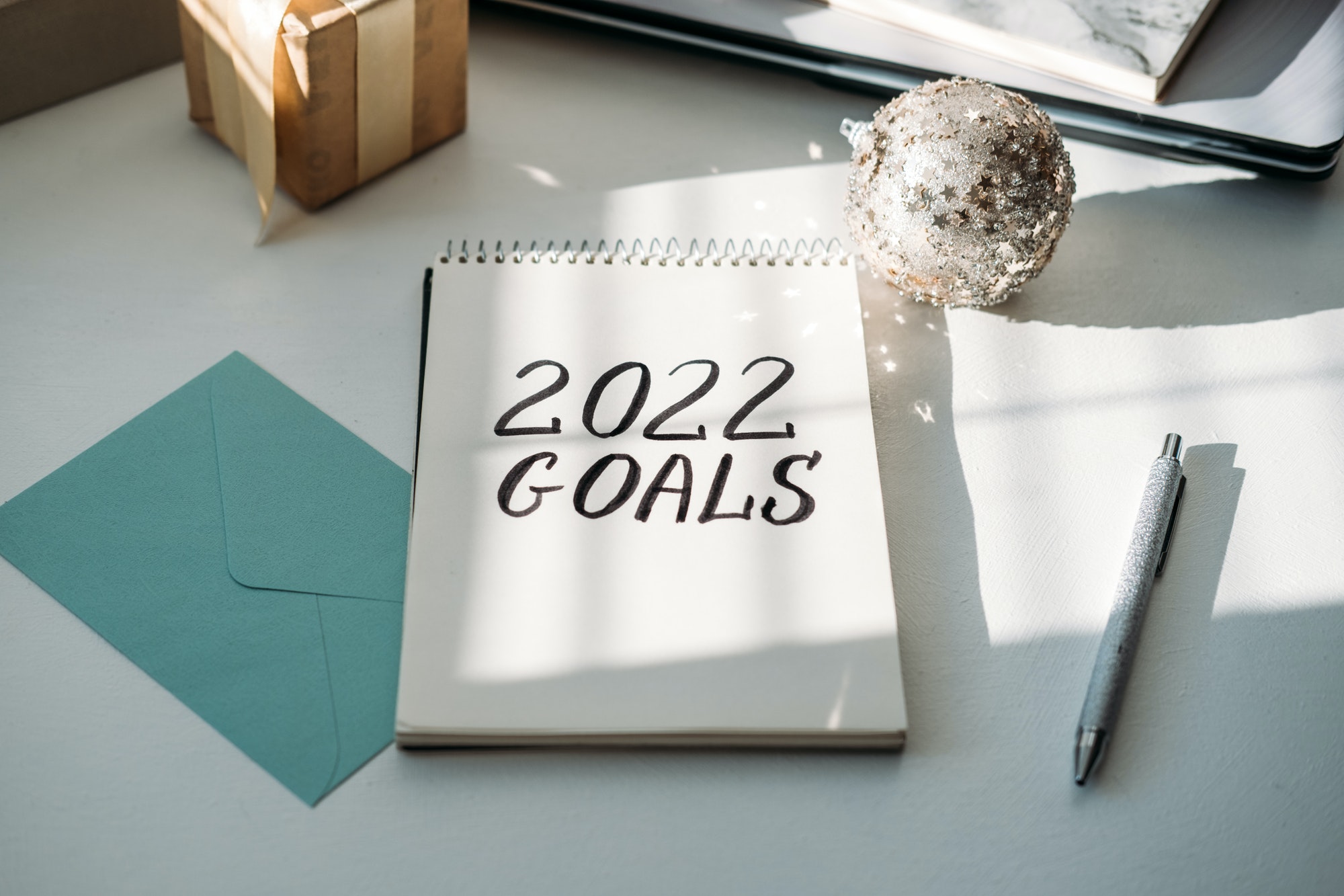 2022 goals, New year resolution. Text 2022 goals in open notepad on the table